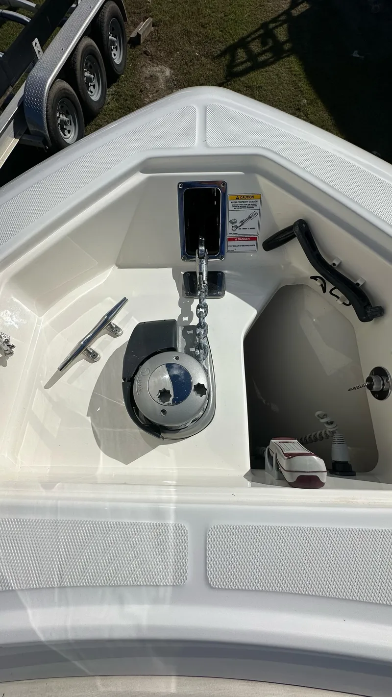 Slide: The Image of 2022 Boston Whaler 330 Outrage boat anchor compartment with chain and cleat. - 20