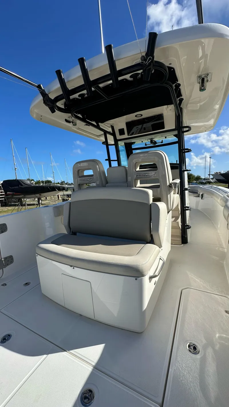 Slide: The Image of 2022 Boston Whaler 330 Outrage boat interior with seating and overhead storage. - 3