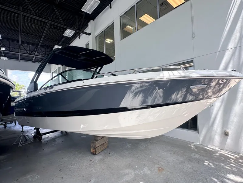 Slide: The Image of 2024 Chaparral 250 OSX boat displayed indoors, showcasing sleek design and modern features. - 0