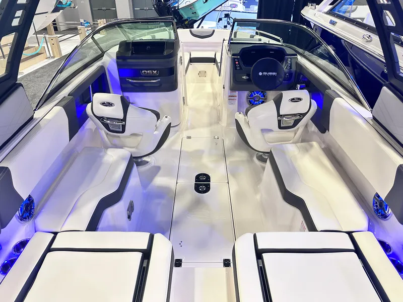 Slide: The Image of 2024 Chaparral 250 OSX OB boat interior with modern seating and ambient lighting. - 14
