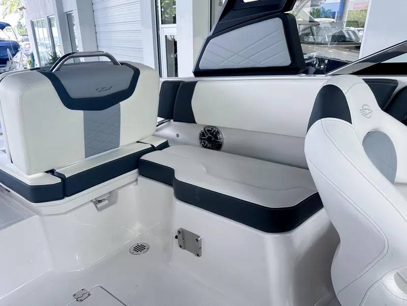 Slide: The Image of 2024 Chaparral 250 OSX OB boat interior with white and navy seating. - 16