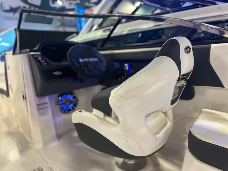 Slide: The Image of 2024 Chaparral 250 OSX OB boat interior with sleek captain's chair and modern dashboard. - 19