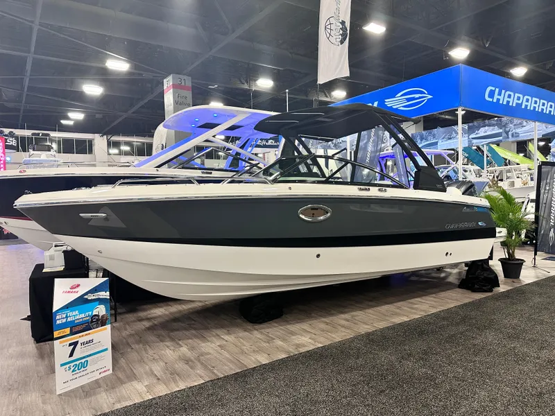 Slide: The Image of 2024 Chaparral 250 OSX OB boat displayed at an indoor exhibition. - 2