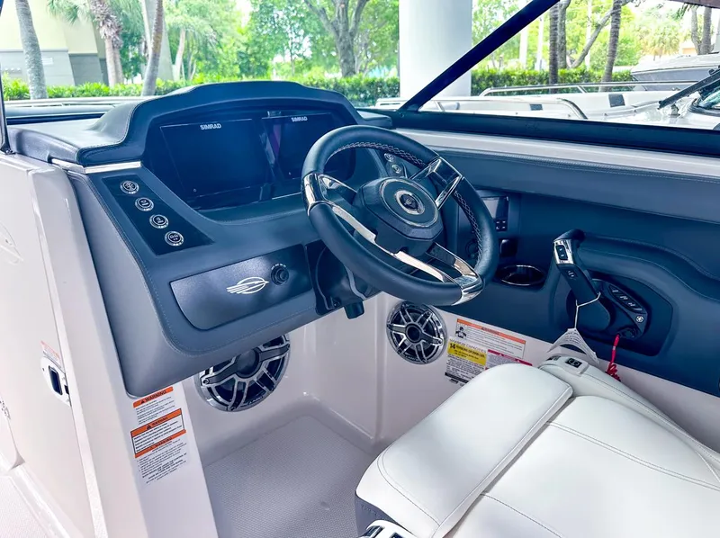 Slide: The Image of 2024 Chaparral 250 OSX OB boat cockpit with modern steering and controls. - 23