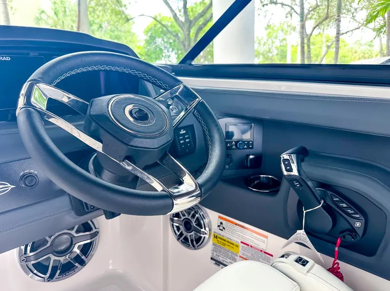 Slide: The Image of 2024 Chaparral 250 OSX OB boat cockpit with steering wheel and controls. - 24