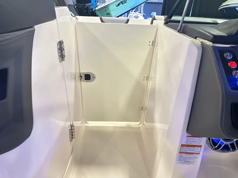 Slide: The Image of 2024 Chaparral 250 OSX OB boat interior with open storage compartment. - 28