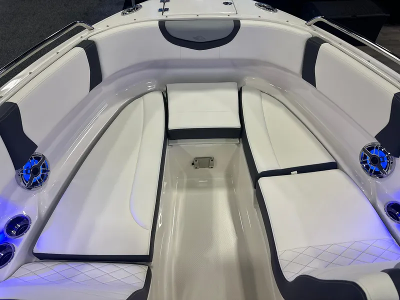 Slide: The Image of 2024 Chaparral 250 OSX OB boat interior with white seating and blue LED lights. - 30