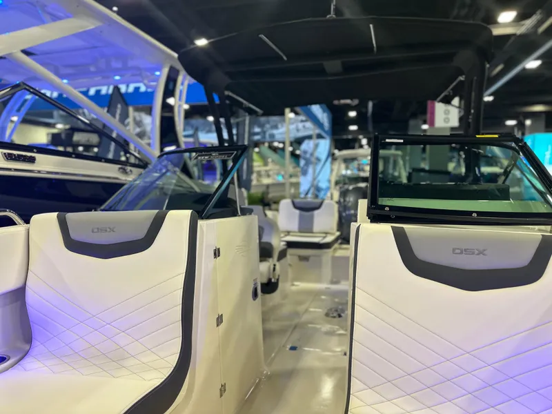 Slide: The Image of 2024 Chaparral 250 OSX OB boat interior at a showroom, featuring sleek seating and modern design. - 31
