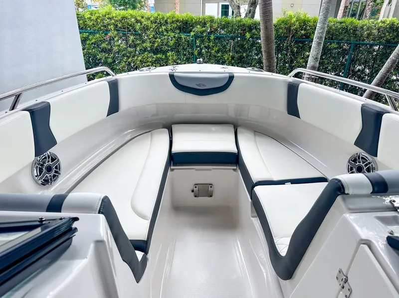 Slide: The Image of 2024 Chaparral 250 OSX OB boat interior with white and black seating. - 35