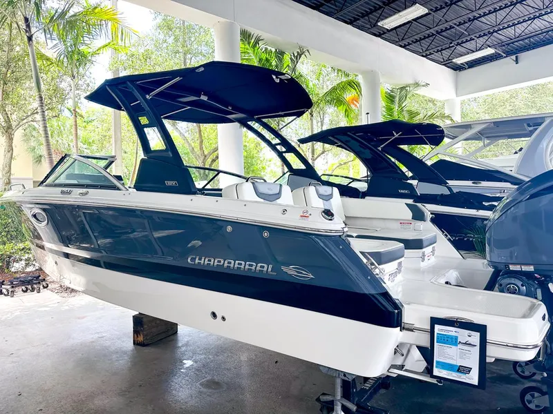 Slide: The Image of 2024 Chaparral 250 OSX OB boat displayed in a showroom, featuring sleek design and modern amenities. - 4