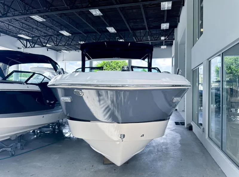 Slide: The Image of 2024 Chaparral 250 OSX OB boat displayed indoors, front view. - 5