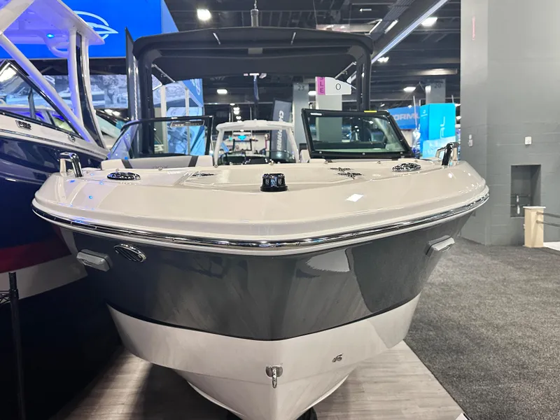Slide: The Image of 2024 Chaparral 250 OSX OB boat displayed at an indoor exhibition. - 6