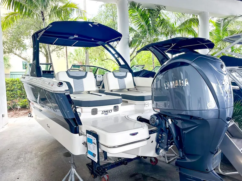 Slide: The Image of 2024 Chaparral 250 OSX OB boat with Yamaha outboard engine, displayed outdoors. - 7
