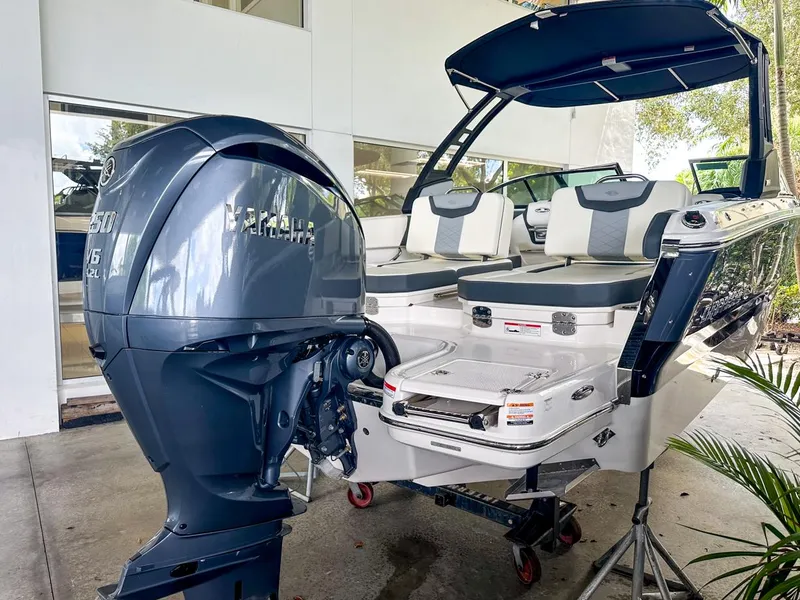 Slide: The Image of 2024 Chaparral 250 OSX OB boat with powerful outboard motor, sleek design, and spacious seating. - 9