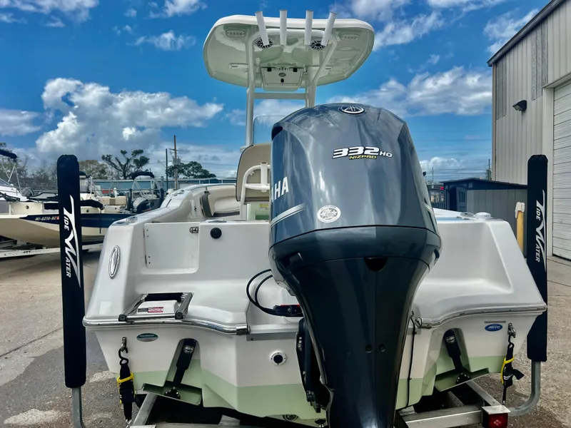 Slide: The Image of 2019 Tidewater 232 CC Adventure boat with Yamaha 332 engine, docked under a cloudy sky. - 16