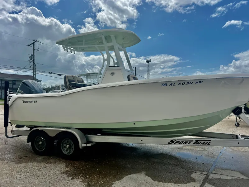 Slide: The Image of 2019 Tidewater 232 CC Adventure boat on trailer under cloudy sky. - 3