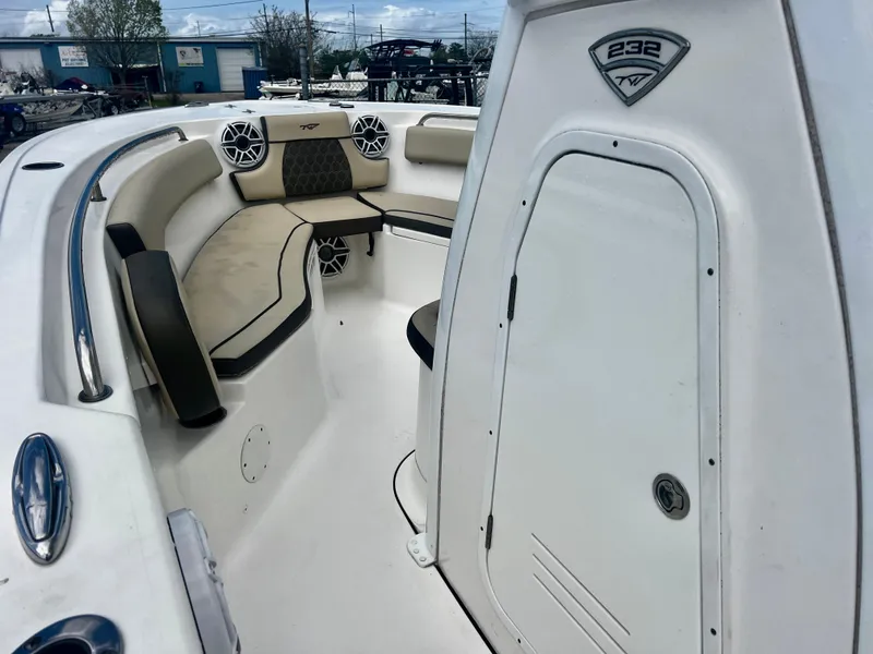 Slide: The Image of 2019 Tidewater 232 CC Adventure boat interior with seating and storage compartment. - 6