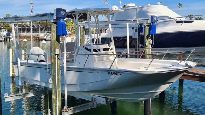 Slide: The Image of 2019 Boston Whaler 210 Montauk boat docked on a lift in a marina. - 1