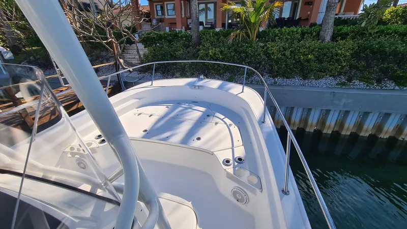 Slide: The Image of 2019 Boston Whaler 210 Montauk boat docked near waterfront homes. - 10