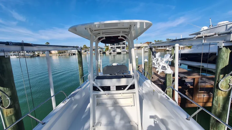 Slide: The Image of 2019 Boston Whaler 210 Montauk docked at a marina under clear blue skies. - 13