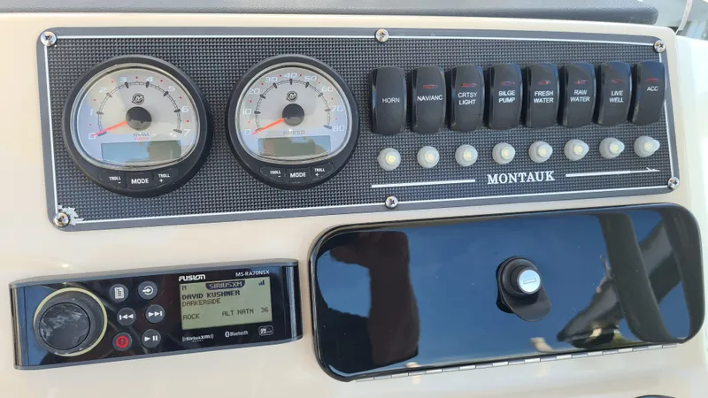 Slide: The Image of Control panel of 2019 Boston Whaler 210 Montauk boat with gauges and switches. - 20