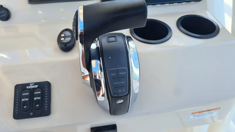 Slide: The Image of Control panel of a 2019 Boston Whaler 210 Montauk boat with throttle and cup holders. - 23