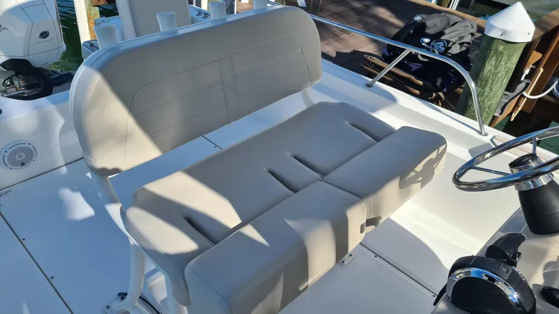Slide: The Image of 2019 Boston Whaler 210 Montauk boat interior with beige seating and steering wheel. - 24