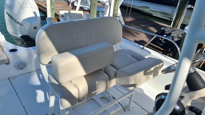 Slide: The Image of 2019 Boston Whaler 210 Montauk boat interior with beige seating and steering console. - 25