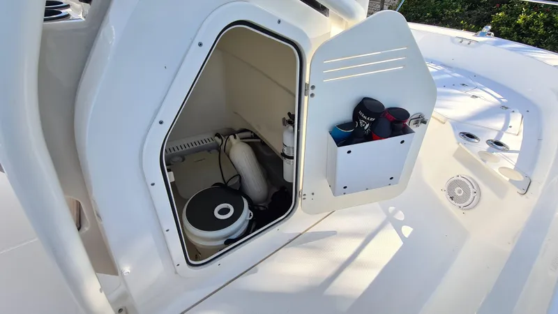 Slide: The Image of 2019 Boston Whaler 210 Montauk storage compartment with marine equipment and accessories. - 29