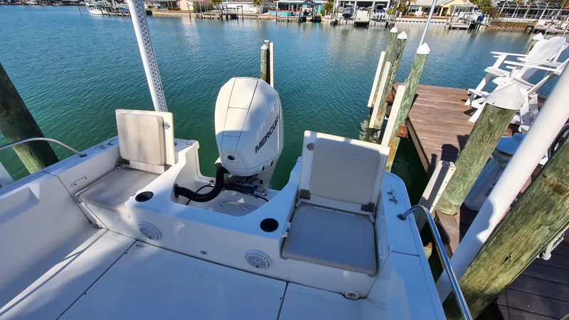 Slide: The Image of 2019 Boston Whaler 210 Montauk boat docked by wooden pier. - 30