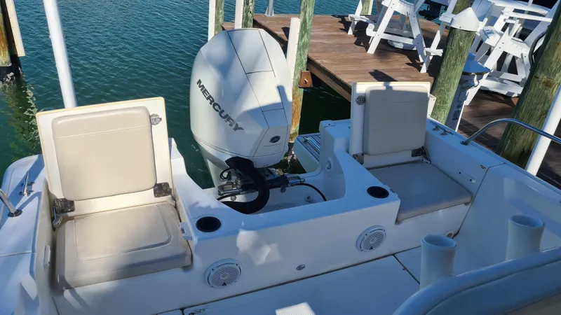 Slide: The Image of 2019 Boston Whaler 210 Montauk boat with Mercury engine, docked by wooden pier. - 31