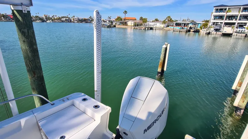 Slide: The Image of Boston Whaler 210 Montauk 2019 boat docked in a serene marina with clear blue water. - 32