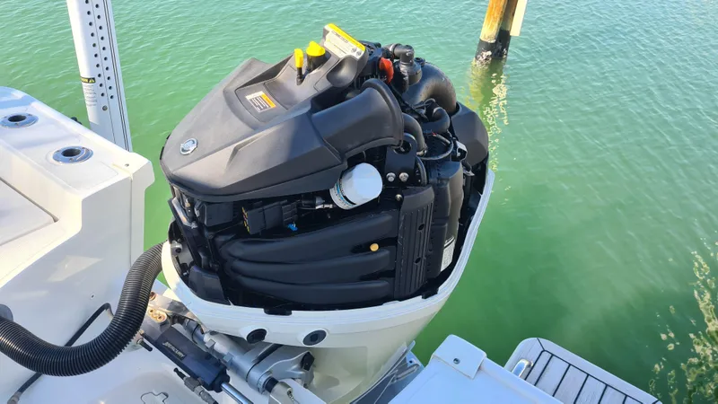 Slide: The Image of 2019 Boston Whaler 210 Montauk outboard motor on calm water. - 34