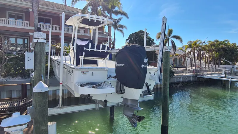 Slide: The Image of 2019 Boston Whaler 210 Montauk boat docked, surrounded by tropical scenery and clear water. - 7