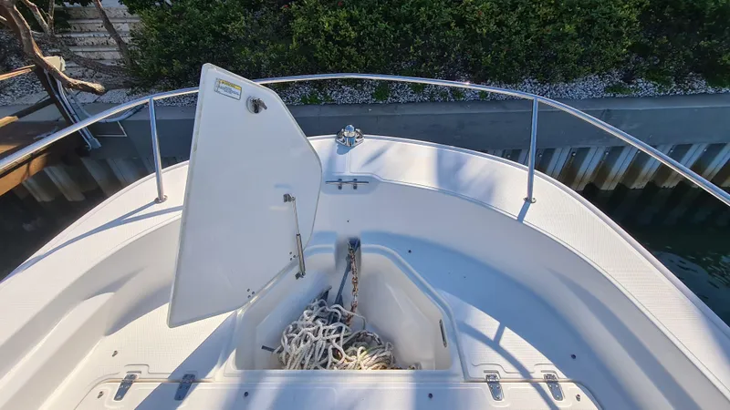 Slide: The Image of 2019 Boston Whaler 210 Montauk bow with open anchor locker and rope. - 9