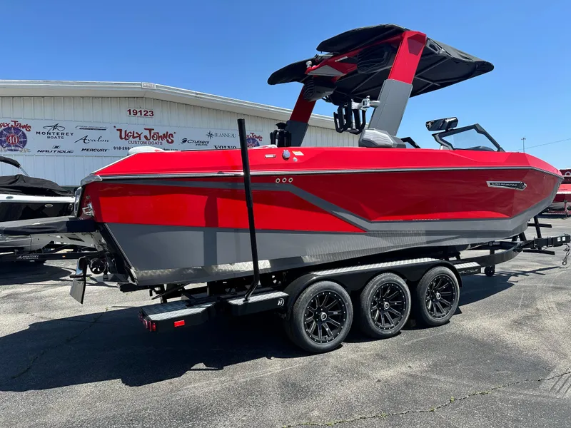 Slide: The Image of 2025 Nautique Super Air Nautique G25 boat in red and gray on a trailer. - 11