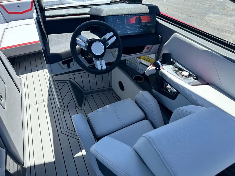 Slide: The Image of Interior of 2025 Nautique Super Air Nautique G25 boat, featuring modern helm and seating. - 18