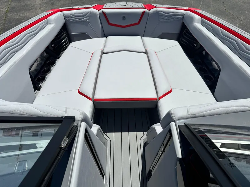 Slide: The Image of 2025 Nautique Super Air Nautique G25 boat interior with gray and red seating. - 23