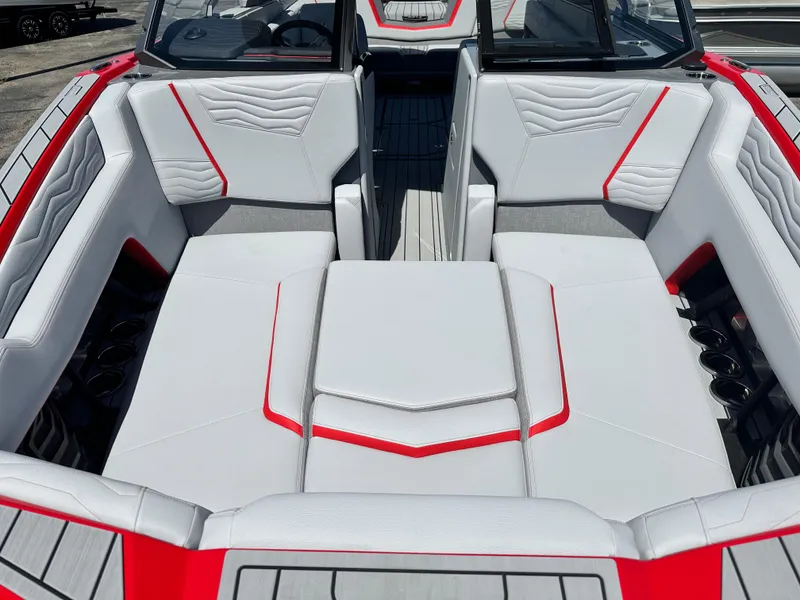 Slide: The Image of 2025 Nautique Super Air Nautique G25 boat interior with white and red seating. - 24