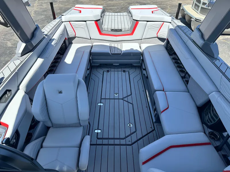 Slide: The Image of 2025 Nautique Super Air Nautique G25 interior with gray seating and red accents. - 25