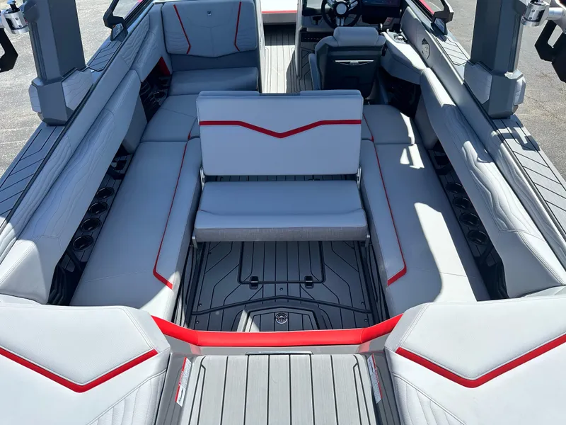 Slide: The Image of 2025 Nautique Super Air Nautique G25 interior with sleek gray and red seating design. - 26