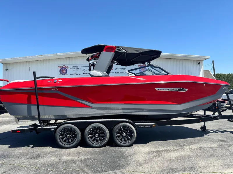Slide: The Image of 2025 Nautique Super Air Nautique G25 boat in vibrant red on a trailer. - 4