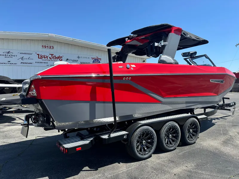 Slide: The Image of 2025 Nautique Super Air Nautique G25 boat in red and gray on a trailer. - 5
