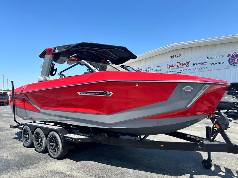 Slide: The Image of 2025 Nautique Super Air Nautique G25 boat in vibrant red on a trailer. - 6