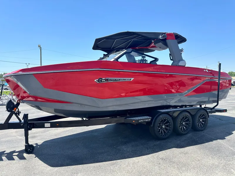 Slide: The Image of 2025 Nautique Super Air Nautique G25 boat in vibrant red on a trailer. - 8