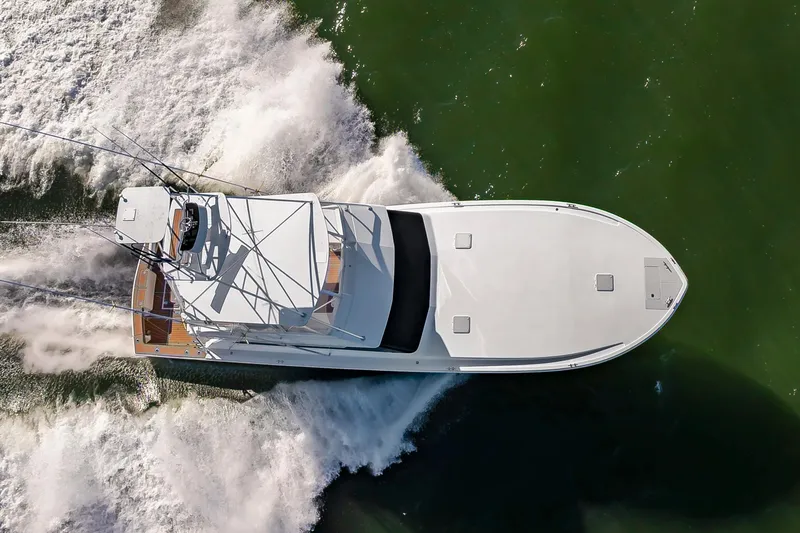 Slide: The Image of Aerial view of a 1999 Viking 58 Convertible yacht cruising through green waters. - 2