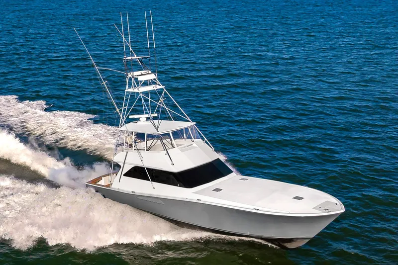 Slide: The Image of 1999 Viking 58 Convertible yacht cruising on open water. - 3