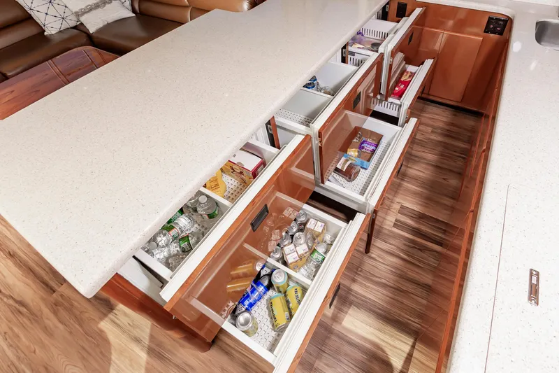 Slide: The Image of Kitchen drawers in a 1999 Viking 58 Convertible yacht, stocked with beverages and snacks. - 33