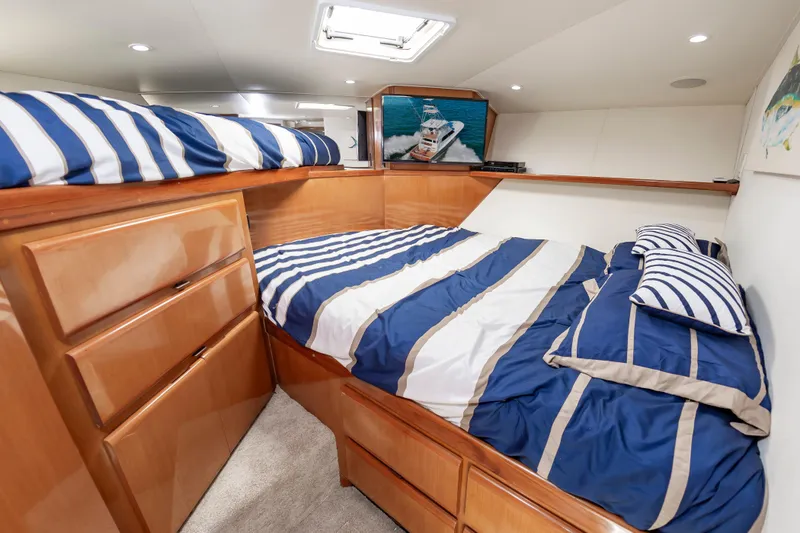Slide: The Image of Luxurious cabin interior of 1999 Viking 58 Convertible yacht with striped bedding. - 45