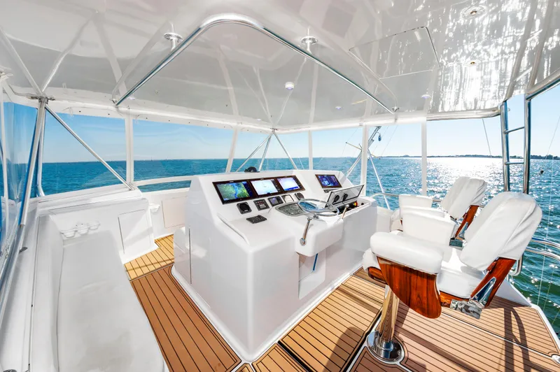 Slide: The Image of Helm of 1999 Viking 58 Convertible yacht with ocean view and modern controls. - 7